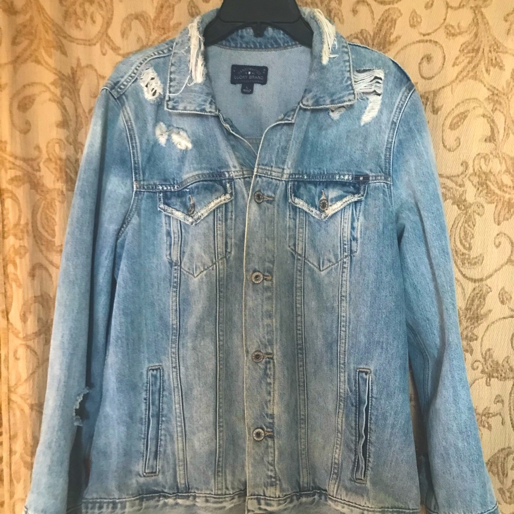Distressed jean jacket, lots of rips and vintage looking. Comfy too